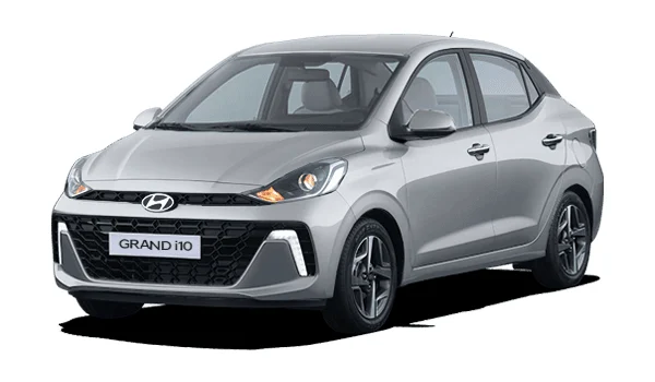 Hyundai Grand i10 Sedán color gris: sedán moderno con diseño sobrio, parrilla oscura, faros envolventes y rines de acero. Ideal para traslados diarios con eficiencia.
