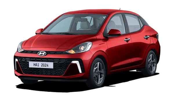 Hyundai Grand i10 Sedán color rojo: sedán compacto con diseño aerodinámico, faros envolventes, parrilla frontal negra y rines de acero. Ideal para conducción urbana con estilo juvenil.